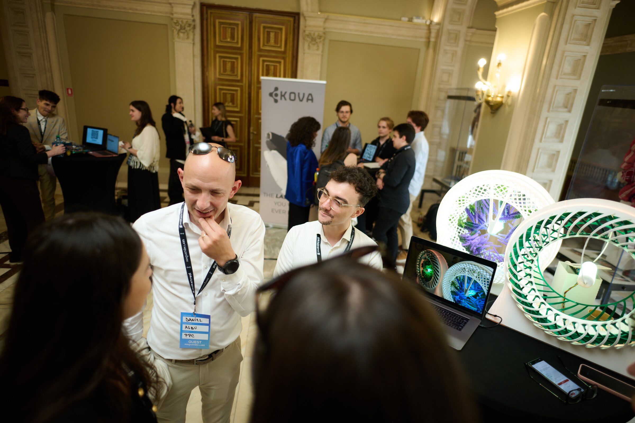 Visitors discussing the FlavoRotor prototype at the expo