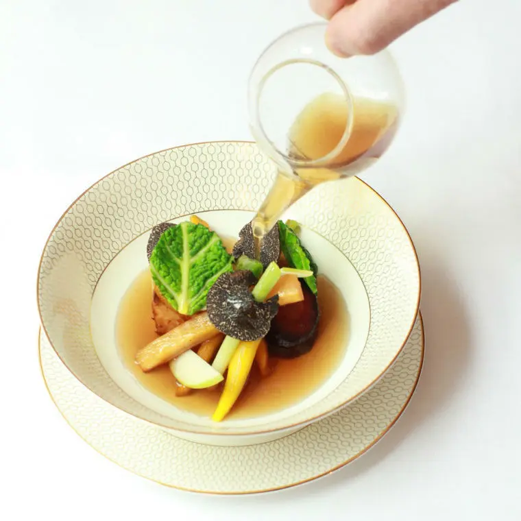 A composed restaurant dish with fresh herbs
